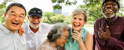group of older adults of different races, laughing together